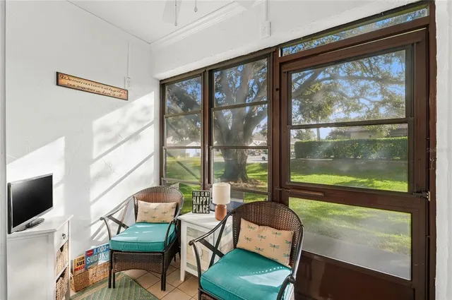 a view of a room with lounge chair and a flat screen tv