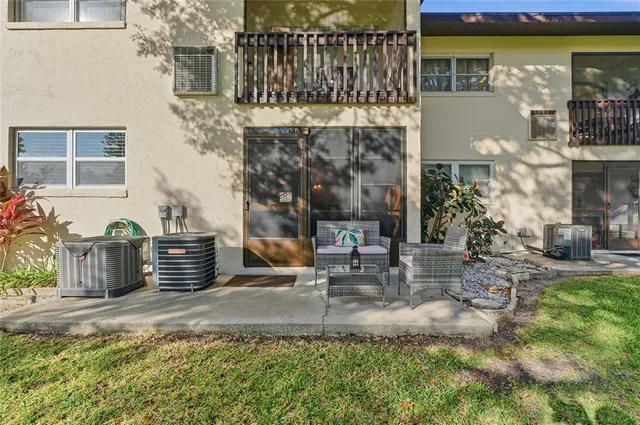 a backyard of a house with outdoor seating