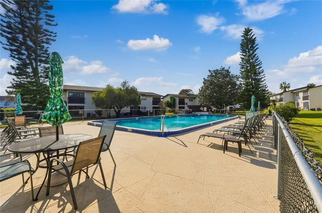 a view of a swimming pool with lounge chairs