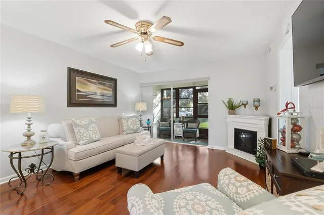 a living room with furniture a fireplace and a flat screen tv
