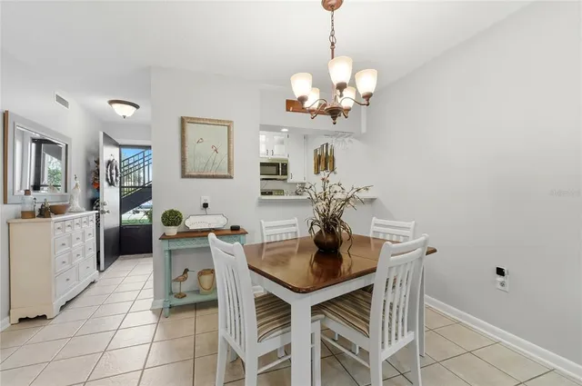 a view of a dining room with furniture and chandelier
