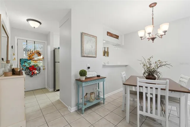 a view of a dining room with furniture and chandelier