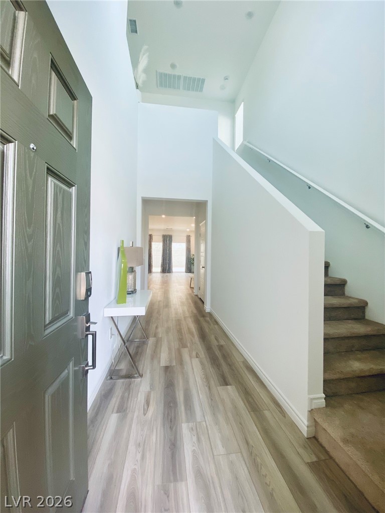 4457 Sawyer Ridge Street Las Vegas, NV 89147 - Photo 8 of 32 Step into a luminous entryway with modern flooring and a grand staircase.