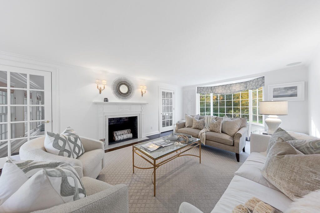 21 Halter Lane Darien, CT 06820 - Photo 13 of 45 a living room with furniture and a fireplace