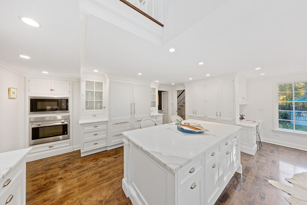 21 Halter Lane Darien, CT 06820 - Photo 21 of 45 a kitchen that has a lot of cabinets in it and wooden floors