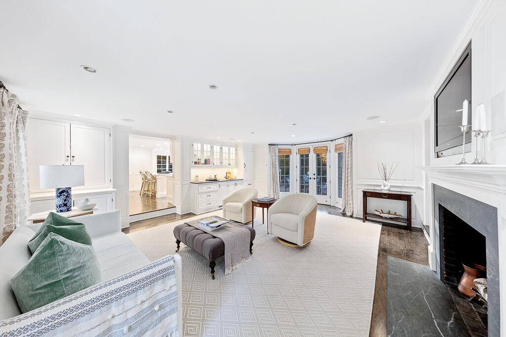 21 Halter Lane Darien, CT 06820 - Photo 23 of 45 a living room with furniture and a fireplace