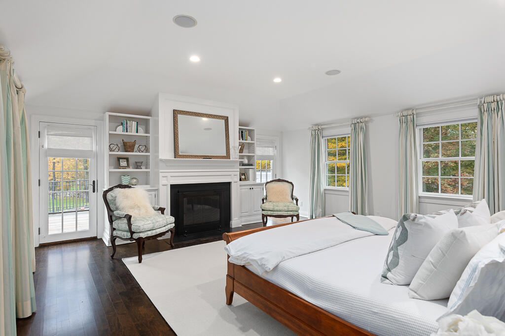 21 Halter Lane Darien, CT 06820 - Photo 27 of 45 a spacious bedroom with a bed and wooden floor