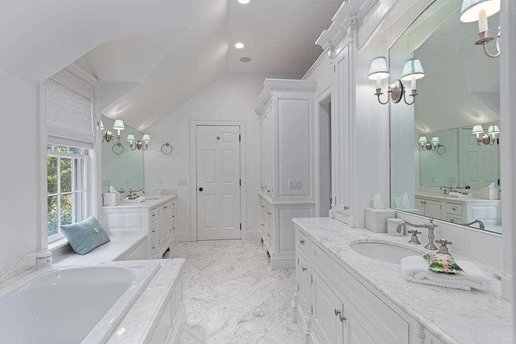 21 Halter Lane Darien, CT 06820 - Photo 29 of 45 a large bathroom with a granite countertop tub a double vanity sink a window and a mirror