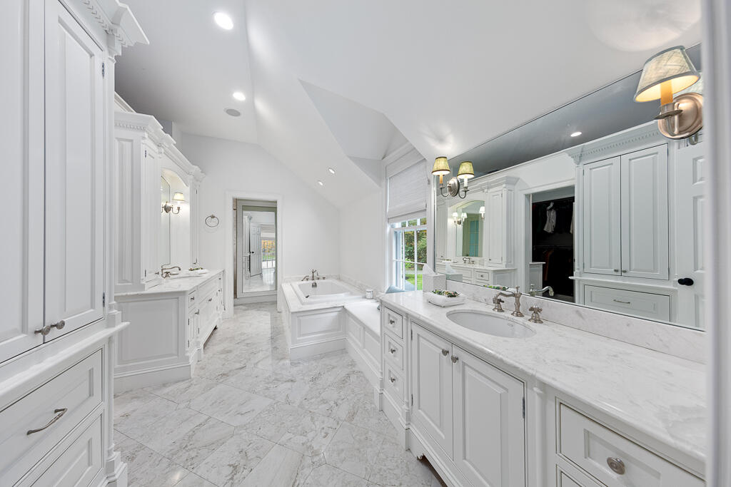 21 Halter Lane Darien, CT 06820 - Photo 30 of 45 a spacious bathroom with a granite countertop sink mirror and a bathtub