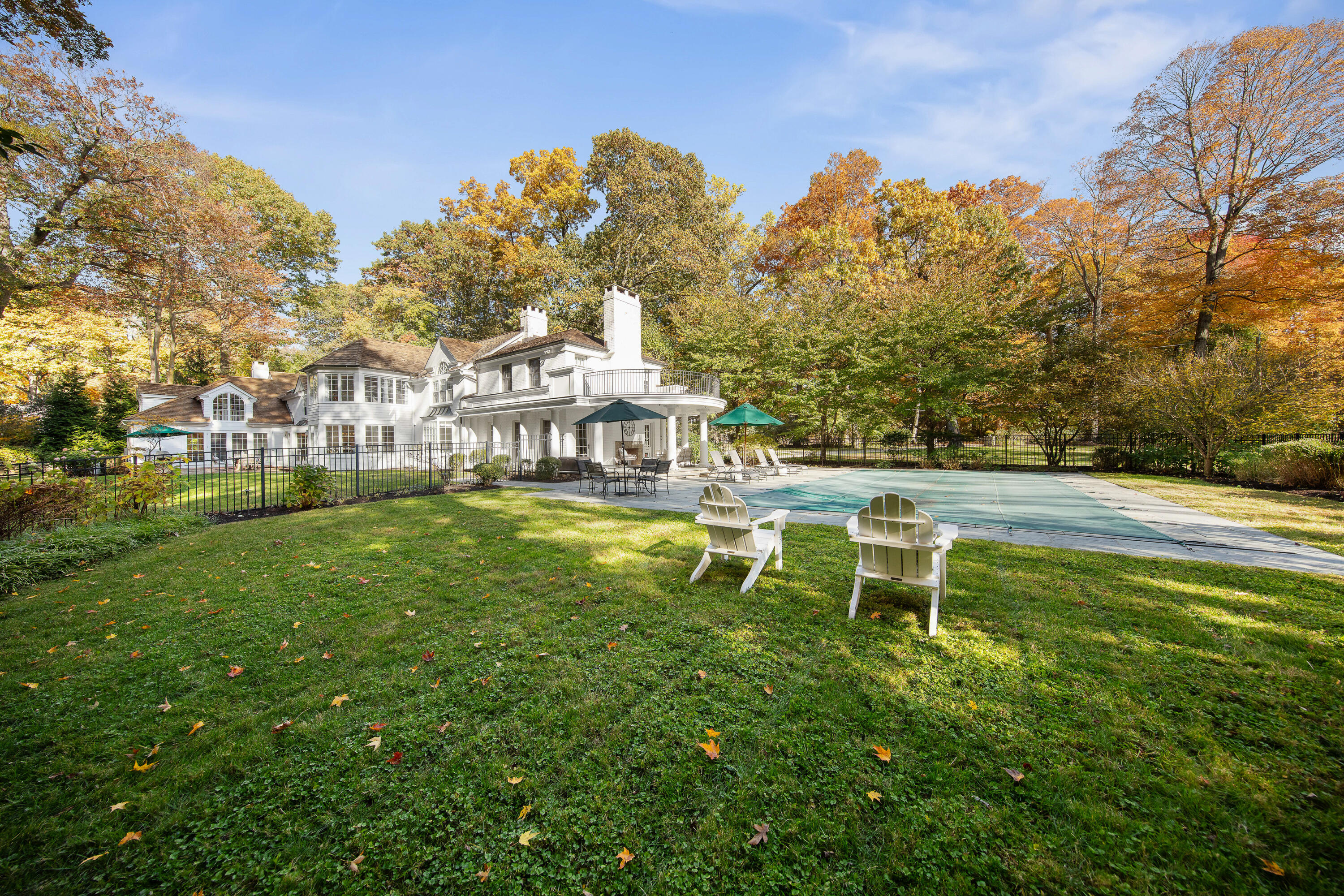 21 Halter Lane Darien, CT 06820 - Photo 5 of 45 a view of a swimming pool with a garden and trees