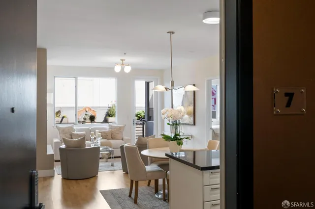 a dining room with furniture and a floor to ceiling window