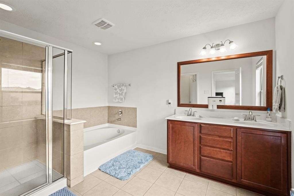 6719 Path Way Court Katy, TX 77449 - Photo 24 of 35 a bathroom with a tub sink and mirror