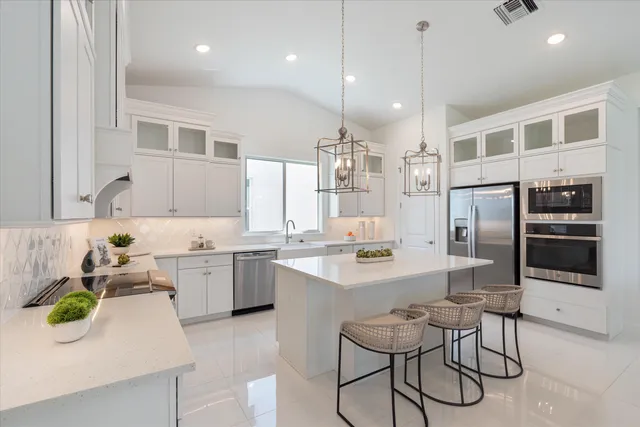 a view of kitchen with stainless steel appliances cabinets and wooden floor