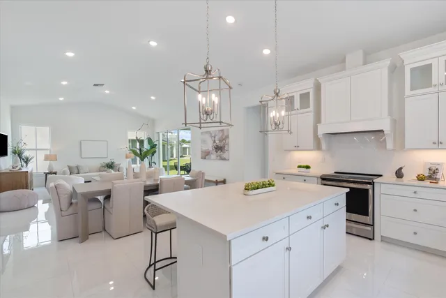 a kitchen with refrigerator and chairs