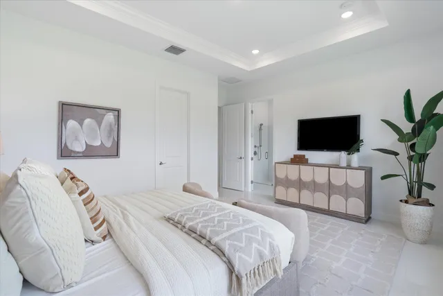 a bedroom with a bed and a large window