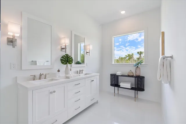 a bathroom with a double vanity sink mirror and double