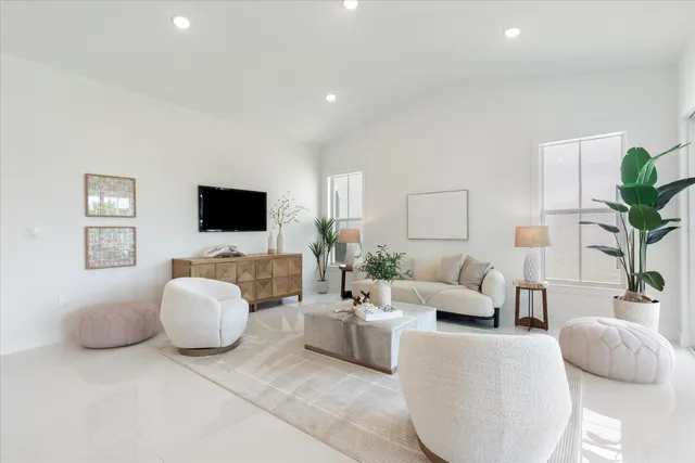 a living room with fireplace furniture and a large window