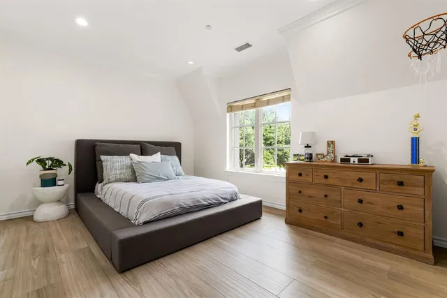 a bedroom with a bed and window