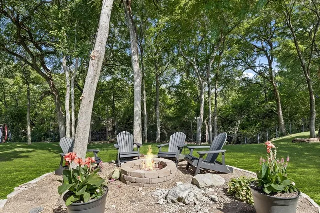 a view of a patio with a table chairs and a fire pit