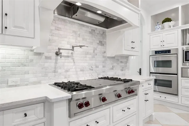 a white stove top oven sitting inside of a kitchen