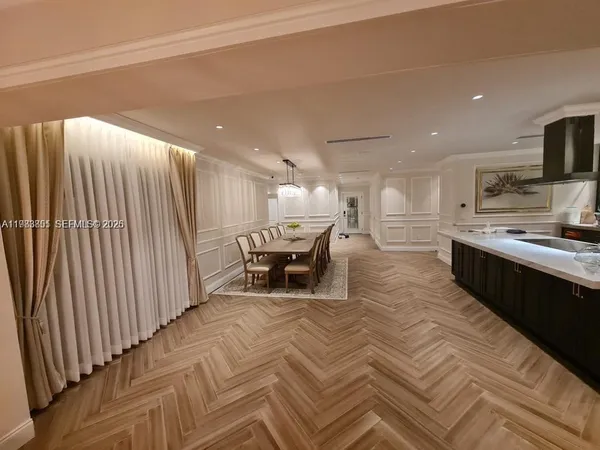 a large kitchen with a large counter top appliances and cabinets