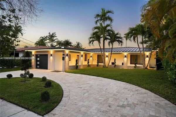 a view of a house with palm trees