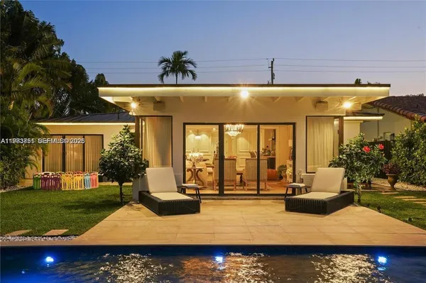 a view of swimming pool with outdoor seating and yard