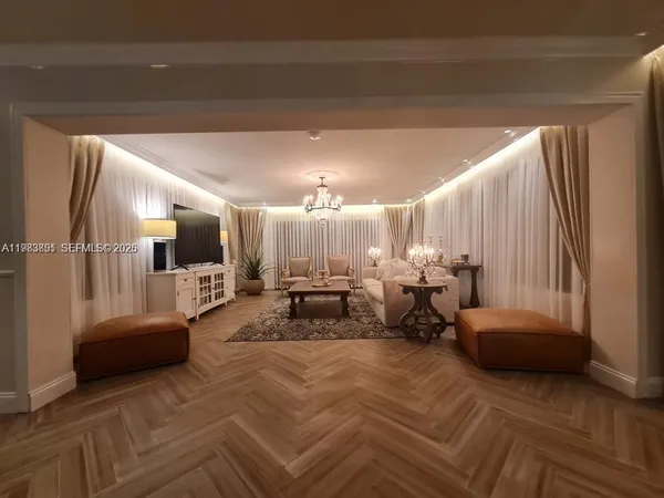 a spacious bedroom with a bed a couch and a large window