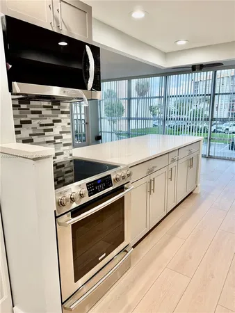 a kitchen with stainless steel appliances a stove and a microwave