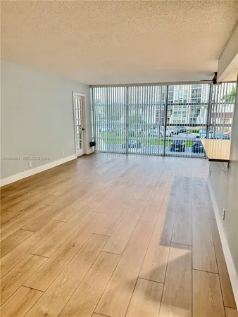 a view of a room with wooden floor and staircase
