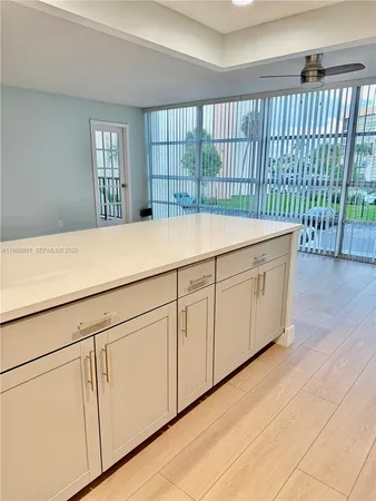 a view of a kitchen with a sink and refrigerator