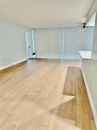 a view of a room with wooden floor