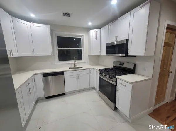a kitchen with a sink stove and microwave