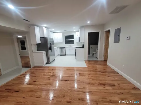 a view of kitchen with furniture and wooden floor