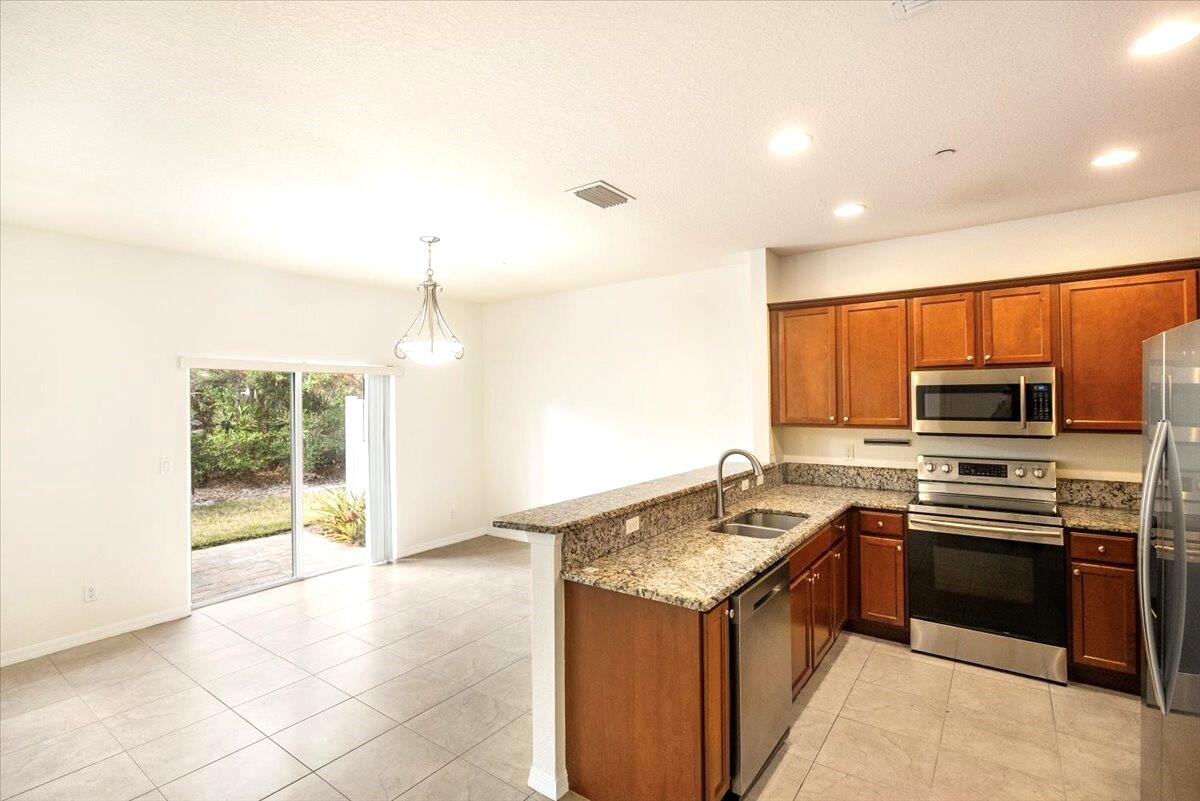 104 Southwest Otter Run Place Stuart, FL 34997 - Photo 22 of 51 104 SW Otter Run kitchen - living