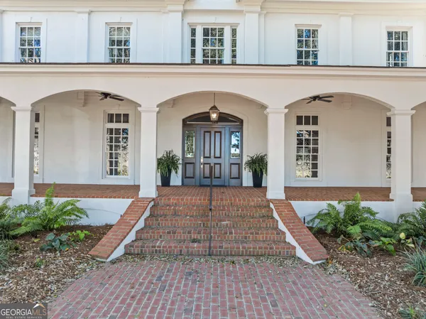a living room with furniture a fireplace and a table