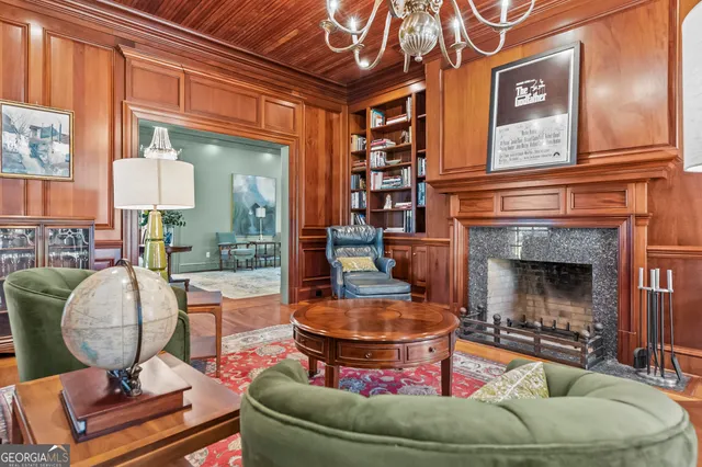 a kitchen with stainless steel appliances a table and chairs in it
