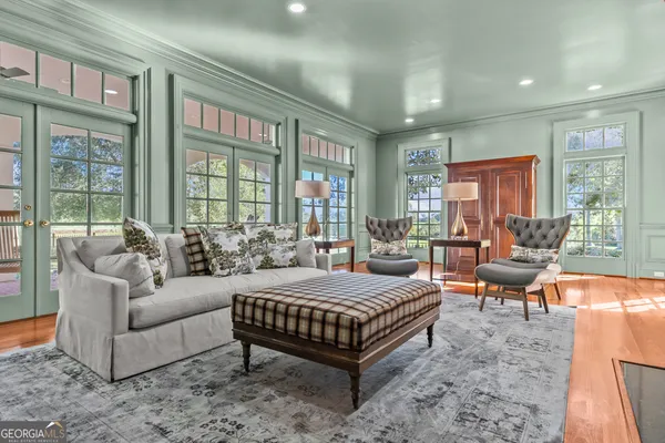 a bedroom with a large bed and a chandelier