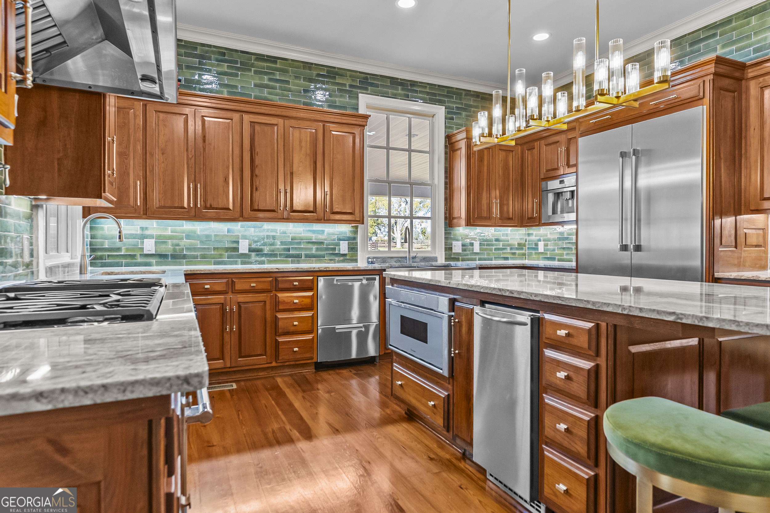 440 Ocilla Highway Fitzgerald, GA 31750 - Photo 28 of 96 a kitchen with granite countertop a stove a sink and a wooden cabinets