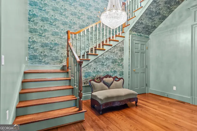 a front view of house with yard and trees in the background