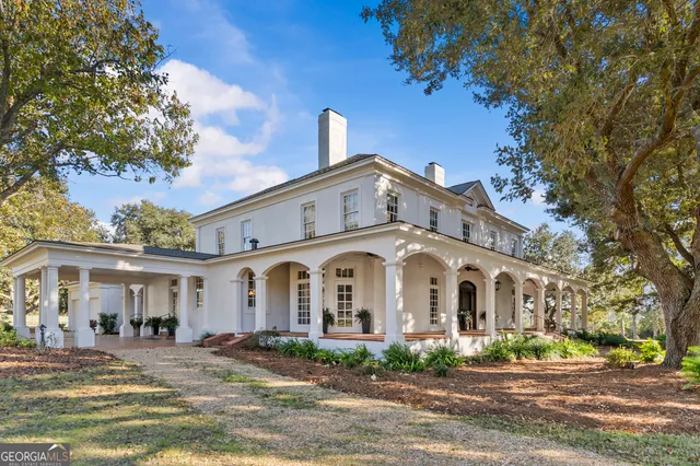 a front view of a house with yard porch and outdoor seating