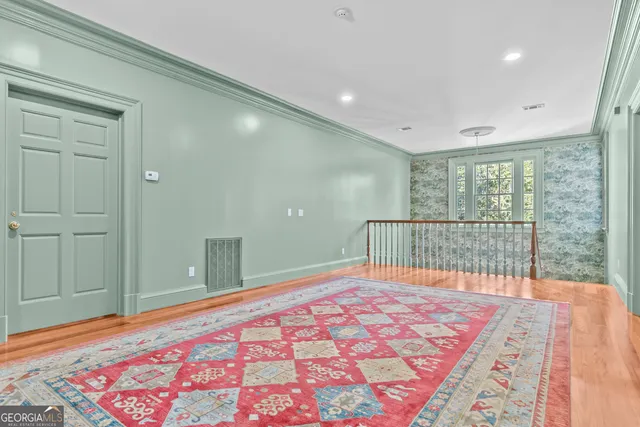a view of a street with potted plants and large trees