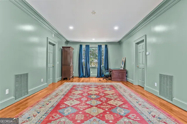 a view of a yard with plants and a large tree
