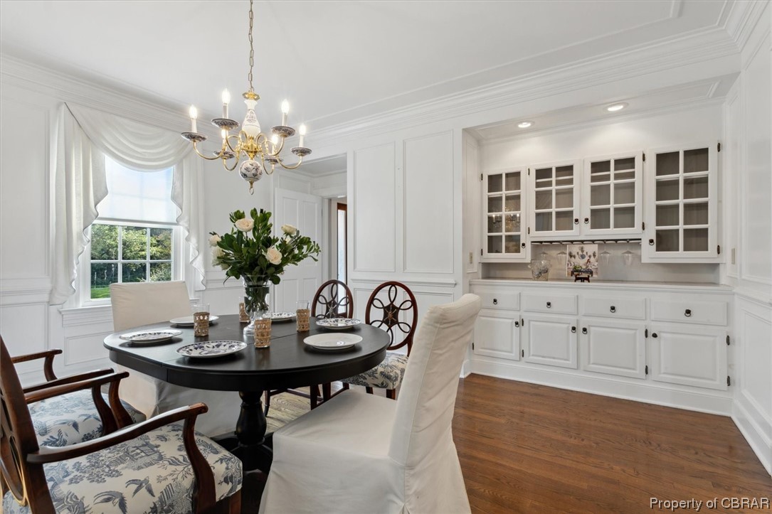 7175 Ware House Road Gloucester, VA 23061 - Photo 8 of 39 Dining area featuring crown molding, a chandelier, and hardwood flooring