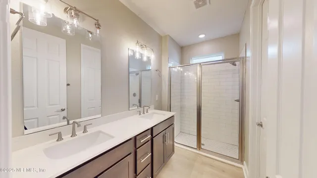 a bathroom with a double vanity sink mirror and double