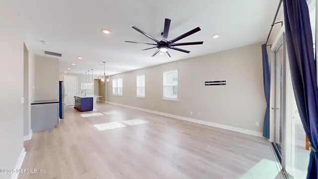 a view of a livingroom with a ceiling fan and window