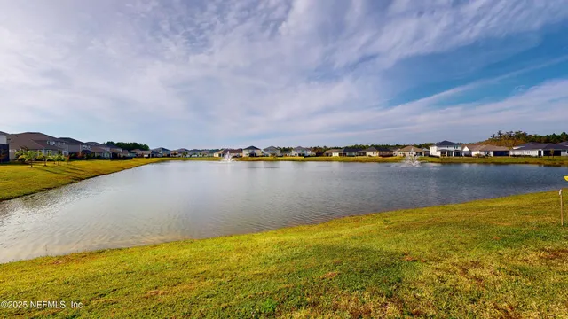 a view of a lake with houses in the back