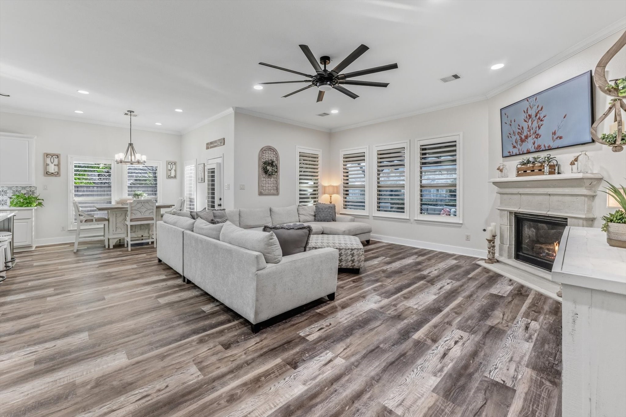 103 Fox Rindle Road Montgomery, TX 77316 - Photo 8 of 44 The stunning living space centered on a sleek gas fireplace, framed by soaring ceilings and walls of windows that flood the room with natural light and architectural drama.