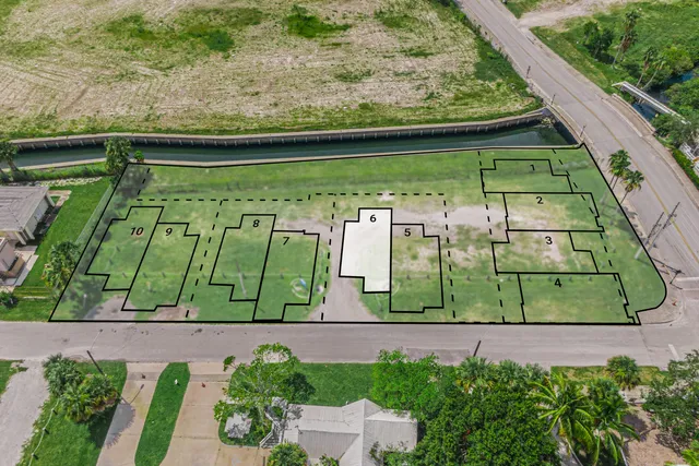 a view of swimming pool with a garden and plants