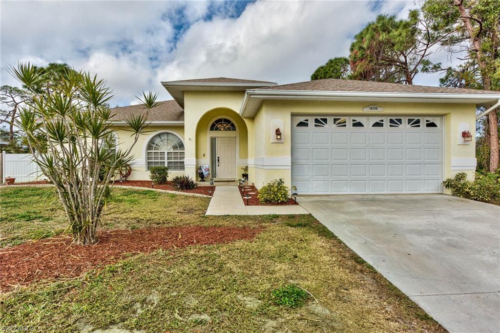 18258 Fuchsia Road Fort Myers, FL 33967 - Photo 1 of 22 a front view of a house with garden